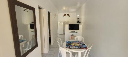 a small dining room with a table and chairs at Pousada Veruschka Santiago in Maragogi