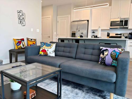 Una sala de estar con un sofá azul y una cocina. en 4BR Townhouse with Lake View & Parking - Sleeps 10 - WV rep 3, en Warrenville