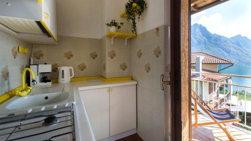 a kitchen with a sink and a view of the ocean at Bellavista Riva in Riva di Solto