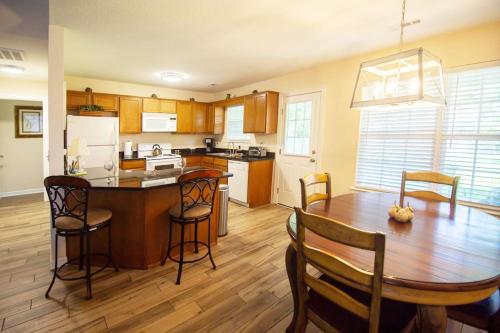 a kitchen with a wooden table and a dining room at Lakeside Getaway - Next to Beaver Lake in Springdale