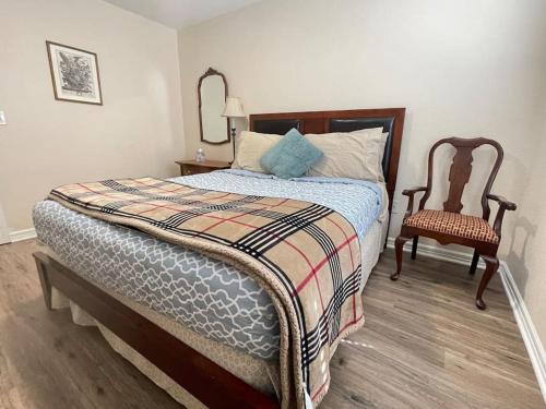 a bedroom with a bed with a mirror and a chair at Lakeside Getaway - Next to Beaver Lake in Springdale