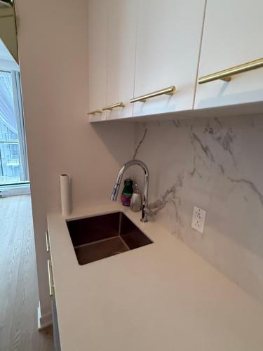 a kitchen with a sink and a counter top at Griffintown luxury 1 open bedroom apartment in Montréal