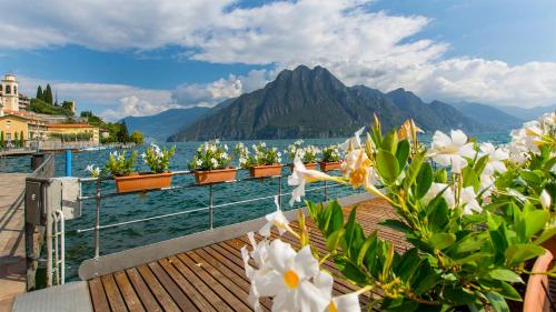 a view of a body of water with flowers at Bellavista Riva in Riva di Solto