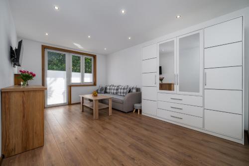 a living room with a couch and a table at Apartament Krokus in Nowy Targ