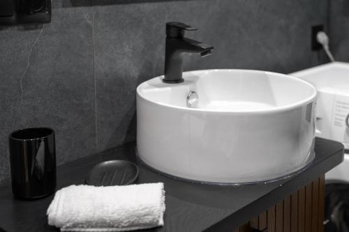 a white sink on a counter in a bathroom at Apartament Krokus in Nowy Targ