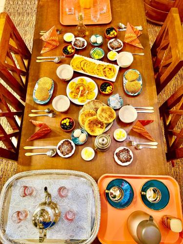 a table topped with plates of food on top at Edwiria Marrakech in Marrakech