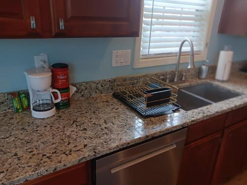 a kitchen counter top with a sink and a counter top at The Vibe in Conyers
