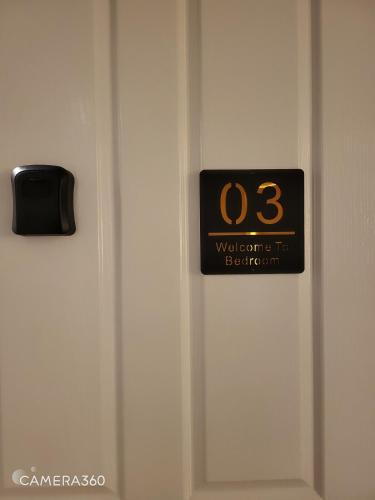 a close up of a door with a clock on it at A Traveller's abode - Room 3 in Craigieburn