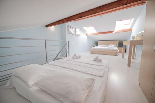 a white bedroom with a bed in a room at Lake View, Old Town, Balcony, Family & Couples APT in Ohrid