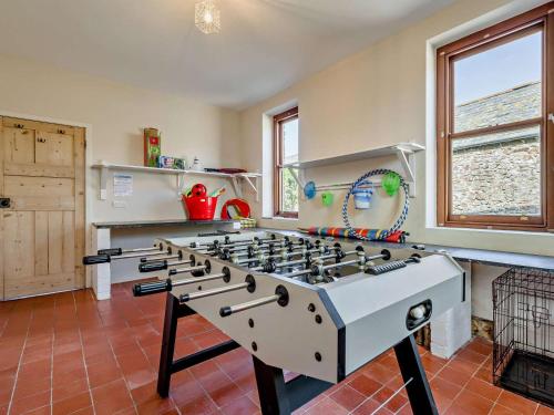 a kitchen with a stove top oven in a room at 4 Bed in Bude SSHAM in Stratton