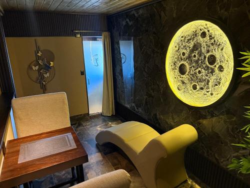 a living room with a yellow chair and a table at Sosua Inn Hotel in Sosúa