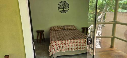 a bedroom with a bed and two stools in it at Sincorá Guesthouse in Lençóis