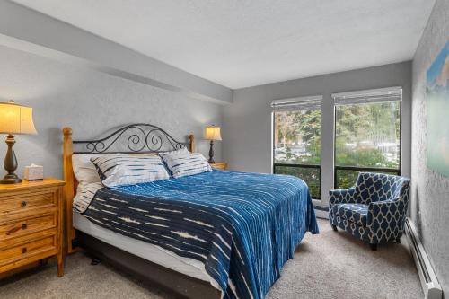 a bedroom with a bed and a chair and a window at Lake Cliffe 108 Building F in Dillon