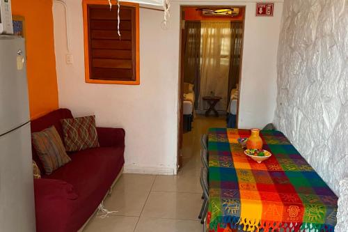 a living room with a table and a couch at Family Retreat In Punta Norte Isla Mujeres in Isla Mujeres