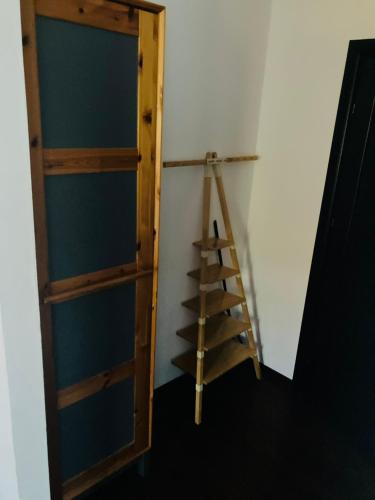 a wooden book shelf in a room with a ladder at Pensiunea Agroturistica Cerna, Vaideeni - Polovragi in Vaideeni