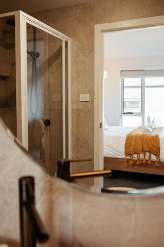 a bedroom with a bed and a mirror at Sunnybank Sea & Stay in St Helens