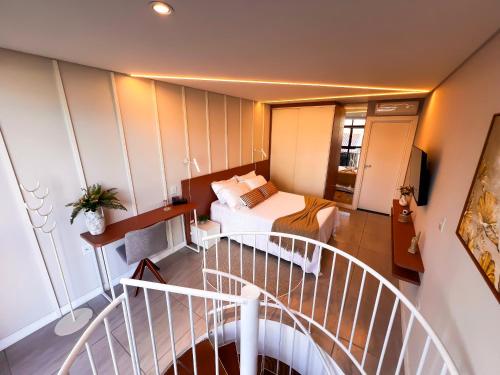 a hotel room with a bed and a staircase at Moderno Loft Urban Beach em Itajai - SC -Praia do Atalaia in Itajaí