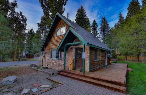 a small house with a wooden deck in the yard at Charming Cherokee Cabin - Secluded Stay for 6 Just 10 Minutes to Tahoe in South Lake Tahoe
