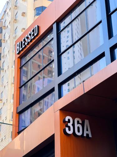 a building with a sign on the side of it at Moderno Loft Urban Beach em Itajai - SC -Praia do Atalaia in Itajaí