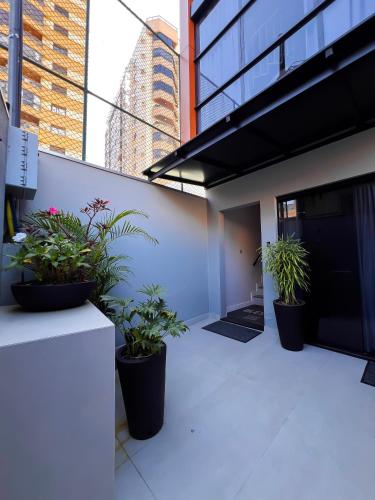 a balcony with potted plants on a building at Moderno Loft Urban Beach em Itajai - SC -Praia do Atalaia in Itajaí