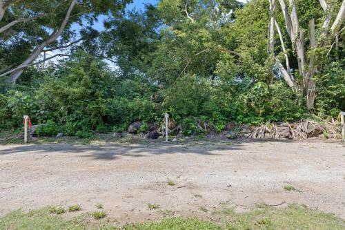 a dirt parking lot with trees in the background at Yandina Caravan Park in Yandina