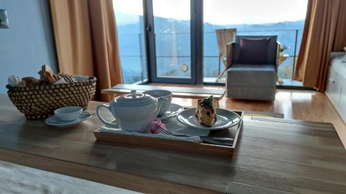 a table with a plate of food and a cup of coffee at ArsDurium Douro hotel in Cinfães
