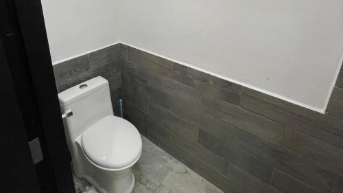 a bathroom with a white toilet in a room at Lavish Studio Balcony #4 Isla Mujeres Downtown in Isla Mujeres