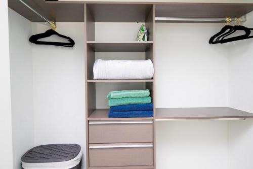 a closet with a toilet and towels in it at Luxe Ventures Miami in Miami