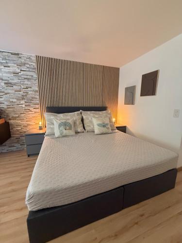 a bedroom with a large bed with two night stands at Holiday Leukerbad Mountain Nature Free Parking Free WiFi in Leukerbad