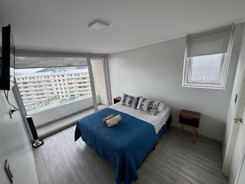 a bedroom with a bed with a teddy bear on it at Edificio Stepke in Temuco
