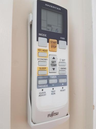 a remote control is attached to a wall at D'entre Cabin in Woodbridge