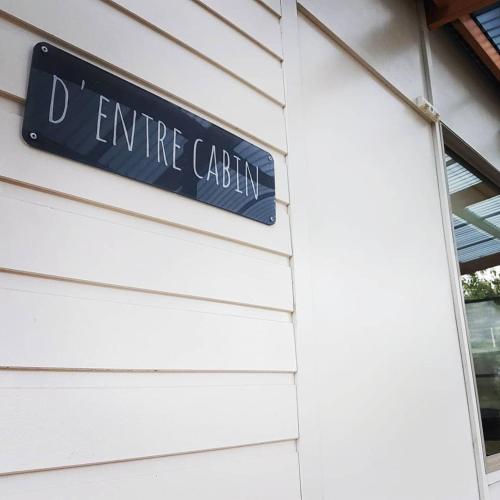 a blue street sign on the side of a building at D'entre Cabin in Woodbridge