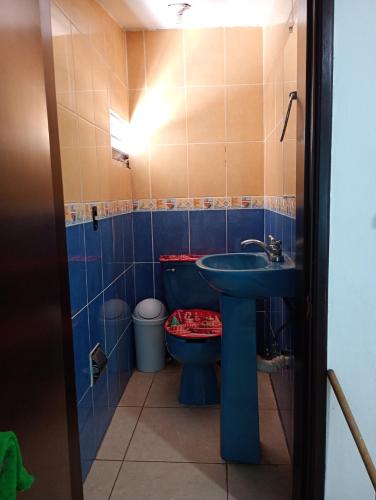a bathroom with a blue sink and a toilet at Casa in Mazatlán