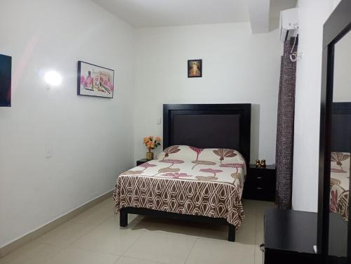 a bedroom with a bed in a white room at Casa in Mazatlán
