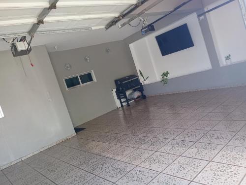 an empty room with white walls and a tile floor at Casa in Mazatlán