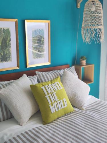 a bed with a pillow that reads take the world at 707,Vista espectacular in Valparaíso