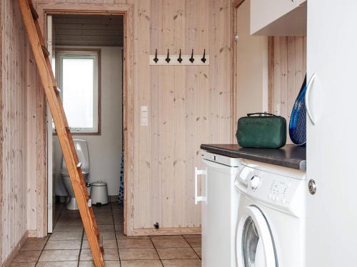 a laundry room with a washer and dryer at 10 person holiday home in Ansager in Ansager