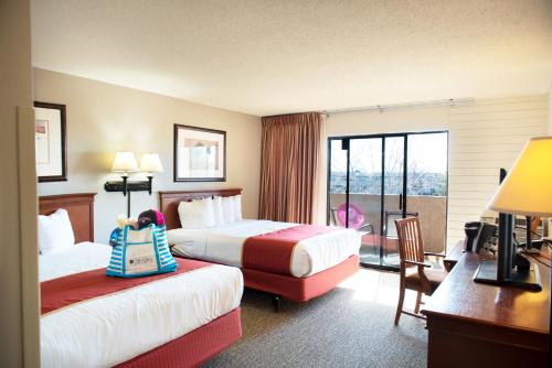 a hotel room with two beds and a balcony at Lake Powell Resort in Page