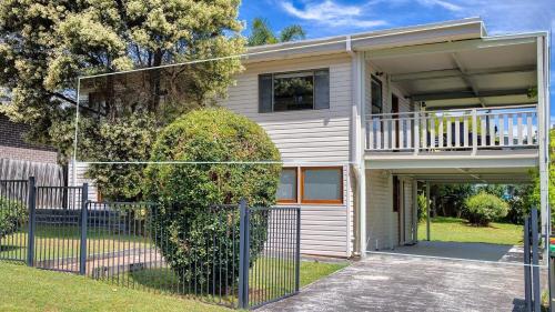 a house with a fence in front of it at Lionel Gem in Shoal Bay