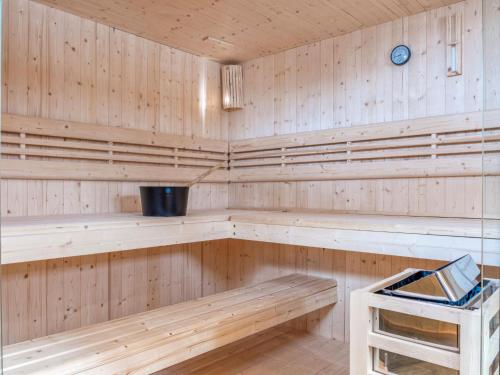 a wooden sauna with wooden shelves and a stool at Hausa Sommer in Grossarl