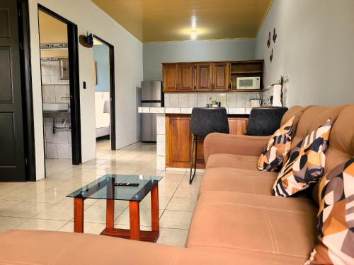 a living room with a couch and a table at Butterfly Apartments in Fortuna