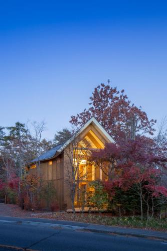 a house with a large window on the side of it at SHISHI-IWA HOUSE Karuizawa in Karuizawa