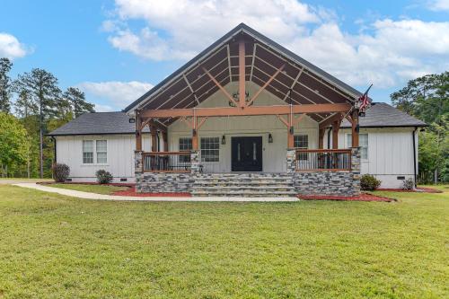 a house with a flag on the front of it at 8 Mi to Jordan Lake Spacious New Hill Home in Apex