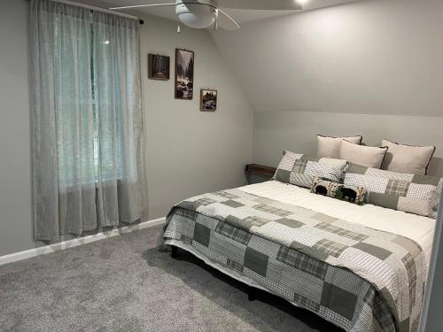 a bedroom with a bed with a checkered blanket at Moosehaven in Campton