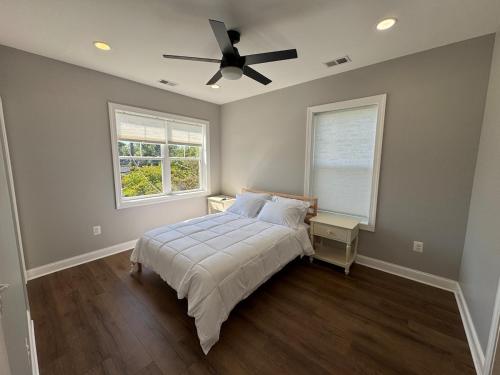 a bedroom with a bed and a ceiling fan at Modern 4BR Family Home with Grill in Silver Spring
