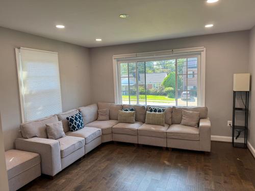 a living room with a couch and a large window at Modern 4BR Family Home with Grill in Silver Spring