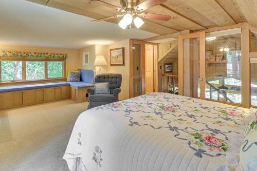 a bedroom with a bed and a chair and a window at Waterfront Escape on Big Sand Lake with Private Dock in Minong