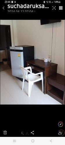a white chair sitting next to a desk and a table at Teahouse in Ban Suan