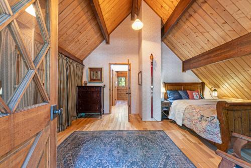 a bedroom with a bed and a wooden ceiling at Classic Cabin in the Pines by Tahoe Getaways - Walk to Lake, Pet-Friendly 3 BR w Yard & Hot Tub! in Tahoe Pines