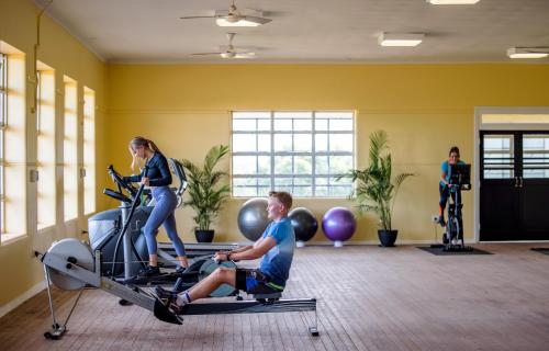 a man and a woman on a treadmill in a gym at Kernow - Minimum age 18 in Charters Towers